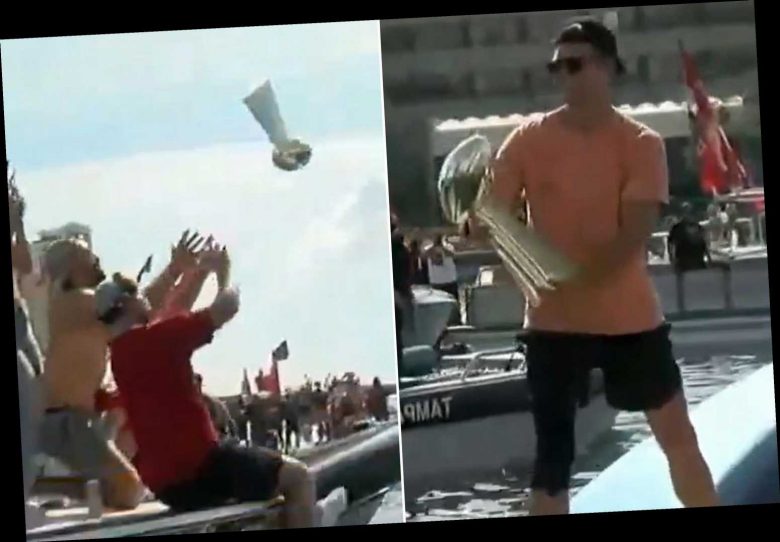 Tom Brady throws Lombardi Trophy to another boat during Super Bowl